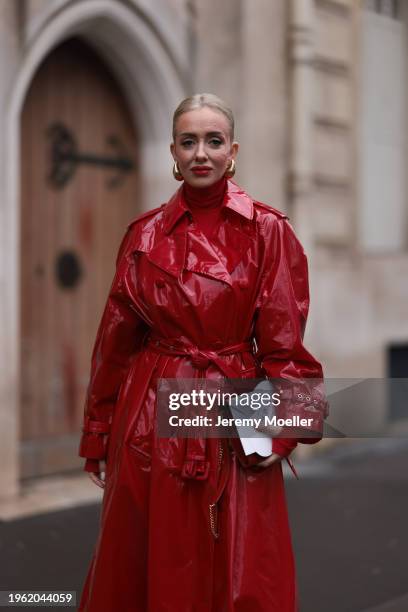Sasha Ray seen wearing Bottega Veneta gold earrings, red high neck knit top, red varnished leather long coat, YSL red varnished leather bag, before...