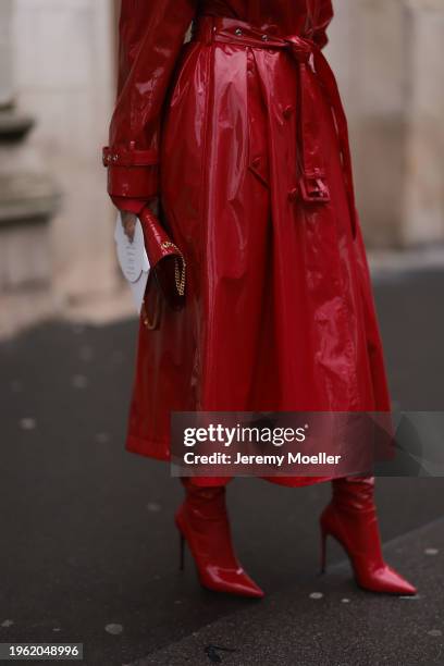 Sasha Ray seen wearing red varnished leather long coat, YSL red varnished leather bag and red varnished leather heeled high boots, overknees, before...
