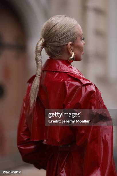 Sasha Ray seen wearing Bottega Veneta gold earrings, red high neck knit top, red varnished leather long coat, before Gaurav Gupta, during the Haute...