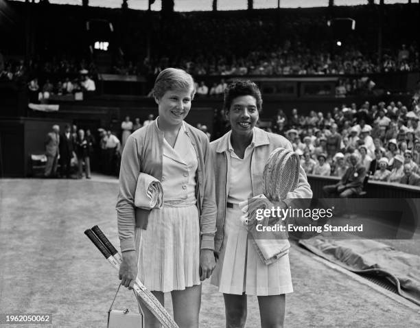 British tennis player Christine Truman and American tennis player Althea Gibson posing ahead of their women's singles semi-final match at the...