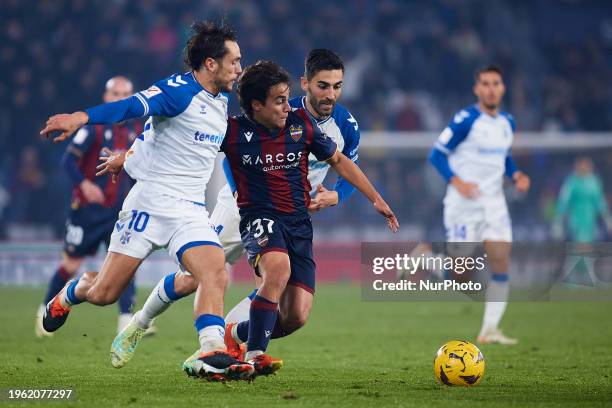 Carlos Alvarez of Levante UD competes for the ball with Alexandre and Leon of CD Tenerife during the LaLiga Hypermotion match between Levante UD and...