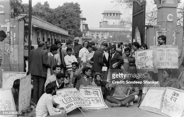 Victims in the Bhopal Gas tragedy case protest against the verdict of the Supreme Court against Union Carbide outside the Supreme Court building in...