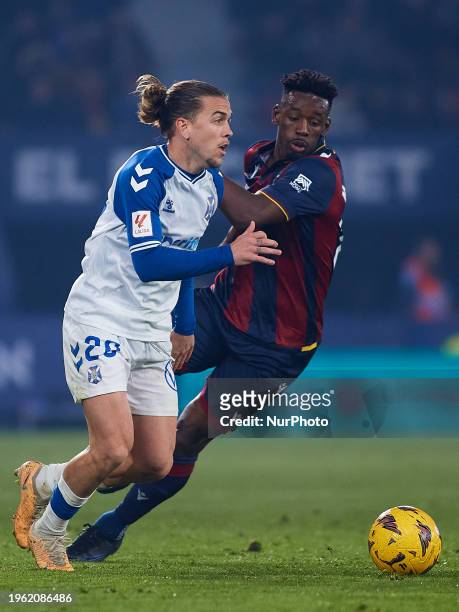 Alvaro Jose Jimenez Guerrero of CD Tenerife competes for the ball with Mohamed Bouldini of Levante UD during the LaLiga Hypermotion match between...