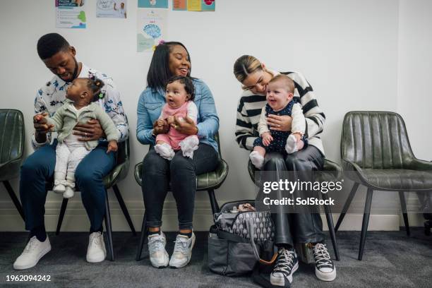 waiting patiently at the baby clinic - mama stock pictures, royalty-free photos & images