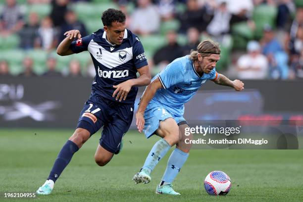 Nishan Velupillay of Melbourne Victory and Anthony Caceres of Sydney FC contest for the ball during the A-League Men round 14 match between Melbourne...