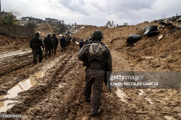 This picture taken during a media tour organised by the Israeli military on January 27 shows Israeli soldiers patrolling an area in Gaza's main...