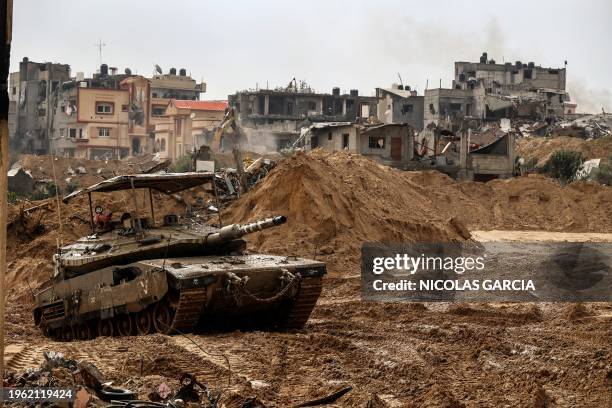 This picture taken during a media tour organised by the Israeli military on January 27 shows an Israeli army tank rolling in Gaza's main southern...