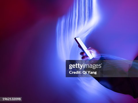 Close-up of using mobile phone on holographic background Close-up of using mobile phone on holographic background