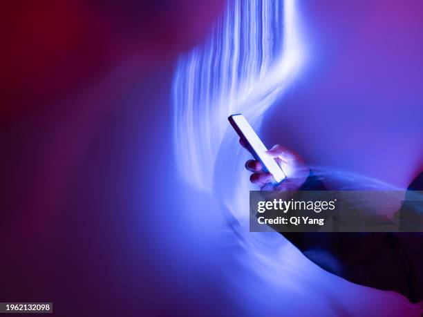 close-up of using mobile phone on holographic background - person on phone stock pictures, royalty-free photos & images