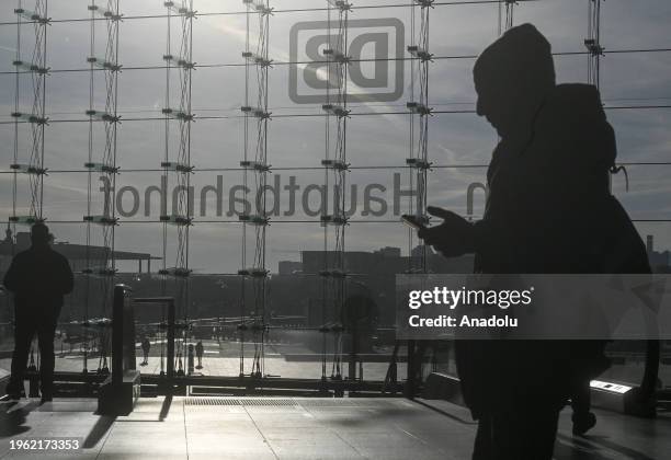 Silhouette of a man looking at his phone is seen at the Berlin Central Train Station as the German Train Drivers' Union ends the last strike earlier...