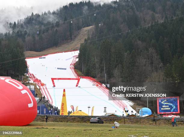 Picture taken on January 27, 2024 shows the ski slope with grass covered areas around, due to warm temperatures and lack of snow, prior to the start...