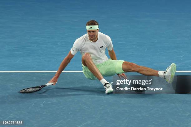 Alexander Zverev of Germany slips attempting to return a ball in their Semifinal singles match against Daniil Medvedev during the 2024 Australian...