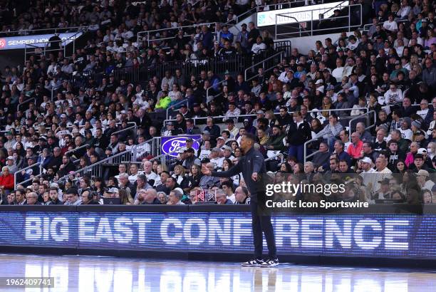 General view of Big East Conference signage as Providence Friars head coach Kim English instructs his players during the college basketball game...