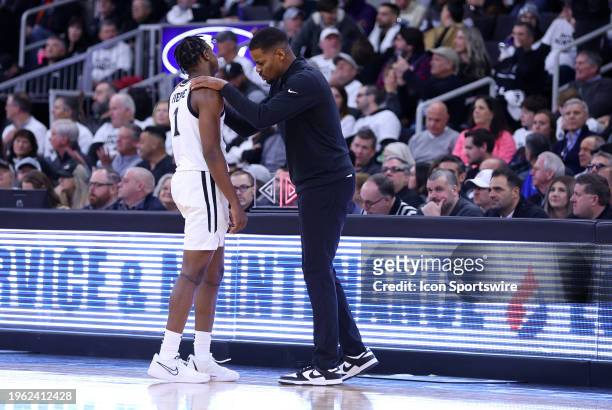 Providence Friars head coach Kim English speaks with Providence Friars guard Jayden Pierre during the college basketball game between Georgetown...