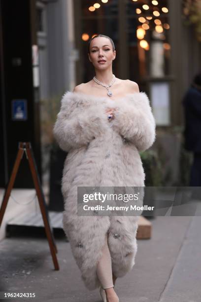 Jurga Fulti seen wearing silver diamond, pearl pendant necklace, cream white fake fur oversized rhinestones embroidered long coat, silver, blue...