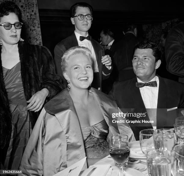 American singer Peggy Lee and her husband, American actor Dewey Martin at their table at the inaugural Audience Awards, held at the Beverly Hilton...