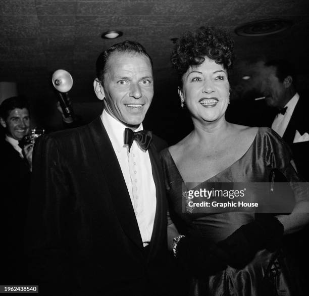 American singer and actor Frank Sinatra, wearing a tuxedo and bow tie, and American singer and actress Ethel Merman, who wears an evening gown and...