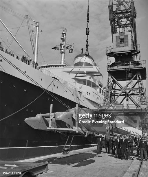 Bluebird K7 being loaded aboard the SS United States ocean liner at Southampton docks, June 25th 1957. Racing driver Donald Campbell is taking his...