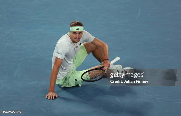 Alexander Zverev of Germany falls attempting to return a ball in their Semi final singles match against Daniil Medvedev during the 2024 Australian...