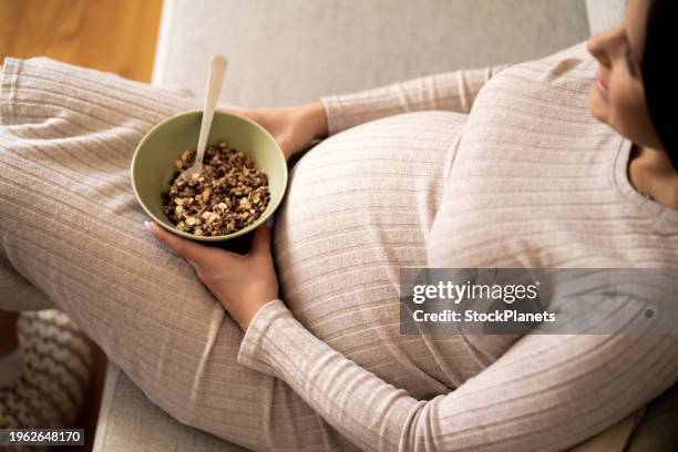 pregnant woman having breakfast at home - body conscious stock pictures, royalty-free photos & images