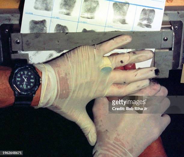 United States Customs Officer fingerprints an individual after he crossed into the United States without proper documentation, January 20, 1995 in...