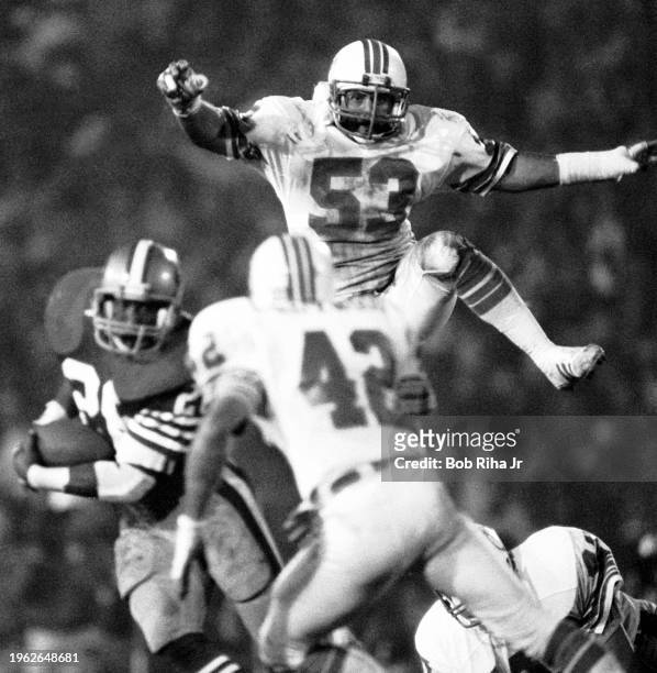 Miami Dolphins Linebacker Jay Brophy jumps over linemen during game action at Super Bowl XIX of Miami Dolphins vs. San Francisco 49ers, January 20,...