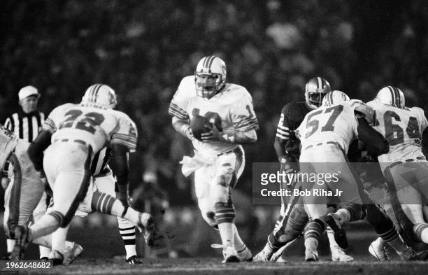 Miami Dolphins Quarterback Dan Marino prepares to hand off to Running Back Tony Nathan during game action at Super Bowl XIX of Miami Dolphins against...