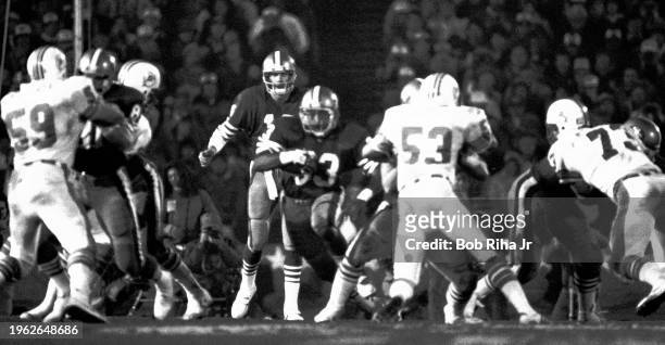 San Francisco Quarterback Joe Montana hands off to Running Back Roger Craig during game action at Super Bowl XIX of Miami Dolphins against San...