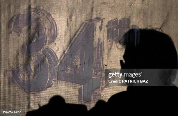 The silhouette of US Hollywood movie star Richard Gere appears near the logo of the 34th Cairo International Festival during a press conference in...