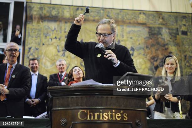 French actor Fabrice Luchini gestures with a hammer as he leads the auction at the Hospices de Beaune's 150th charity auction wine sale, on November...