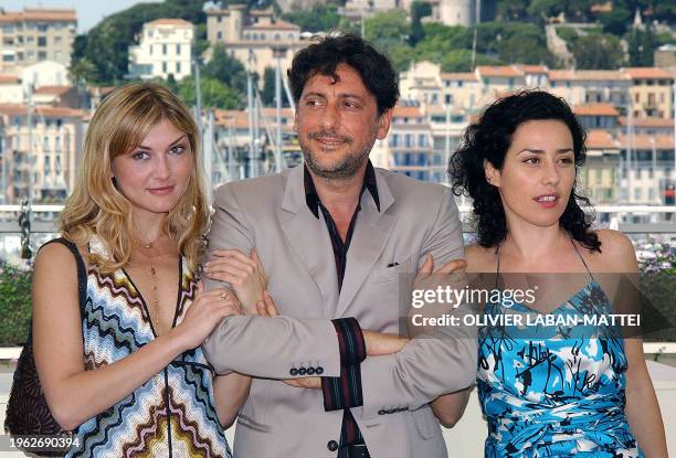 Italian actors Chiara Conti, Sergio Castellitto and Jacqueline Lustig pose for photographers on a terrace of the Palais des festivals during the...