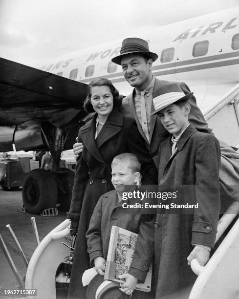 American actor Cyd Charisse and singer Tony Martin with their sons Nico and Tony Martin Jr at London Airport, June 26th 1956.