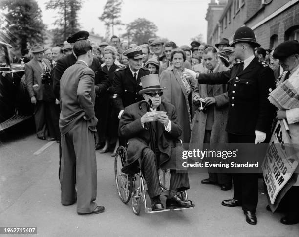 The Aga Khan III arriving for the first day of Royal Ascot in a wheelchair, Berkshire, June 6th 1956.