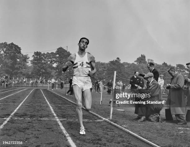 British long-distance runner Gordon Pirie in action on a running track, June 12th 1956.