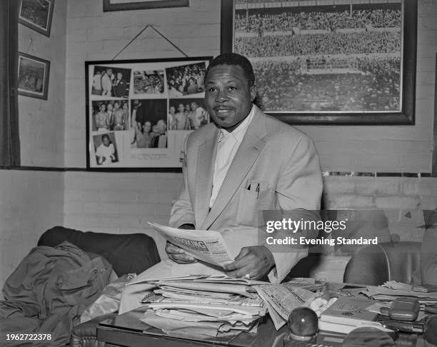 American boxer Archie Moore in the office of promoter Jack Solomons in London, June 9th 1956. He is pictured after beating Yolande Pompey at the...