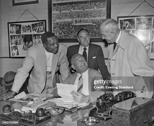 American boxer Archie Moore , boxing managers Charles Johnston and Jack Kearns in the office of boxing promoter Jack Solomons , London, June 9th 1956.