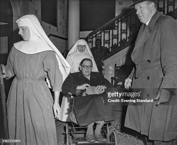 British writer TS Eliot is taken off the RMS Queen Mary in a wheelchair and transported to a local hospital, Southampton, June 14th 1956. Eliot had...