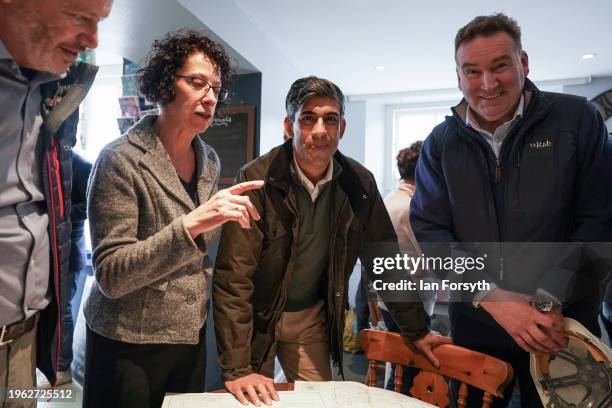 Prime Minster Rishi Sunak looks at building plans as he visits Corn Mill Tearoom in the village of Bainbridge to meet constituents involved with the...