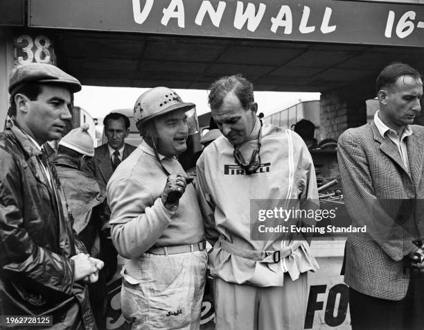 Argentine racing driver Jose Froilan Gonzalez and American racing driver Harry Schell in the pits at Silverstone circuit during the British Grand...