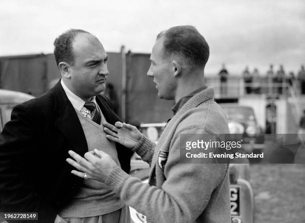 Jose Froilan Gonzalez and Stirling Moss at the 1956 British Grand Prix at Silverstone circuit in Northamptonshire, July 14th 1956.