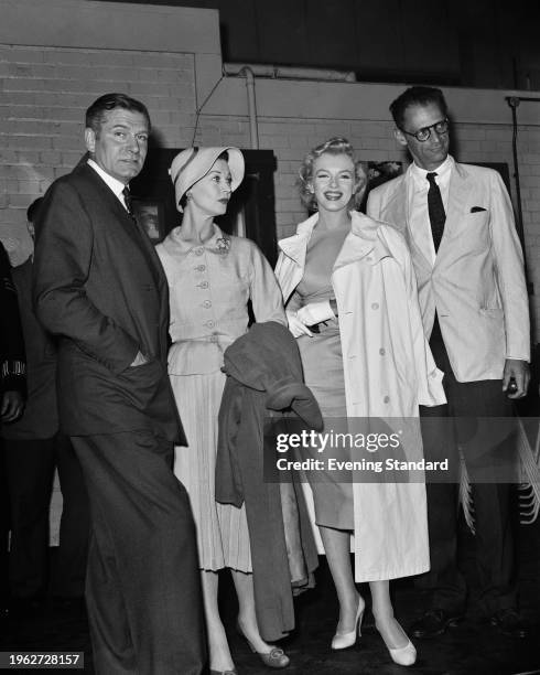 American film star Marilyn Monroe , with her husband Arthur Miller , being greeted by Sir Laurence Olivier and his wife Vivien Leigh on arrival in...