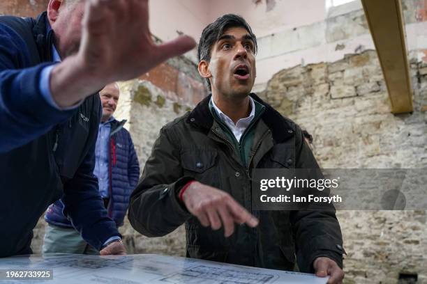 Prime Minster Rishi Sunak views building plans as he visits the village of Bainbridge to meet constituents involved with the renovation of a former...