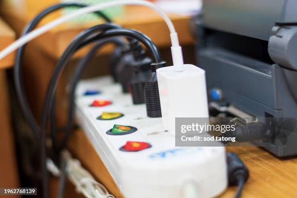 plug the power plug, multiple socket with connected plugs. - toma eléctrica fotografías e imágenes de stock