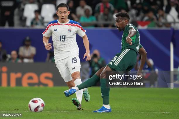 Abdullah Al-Khaibari of Saudi Arabia in action under pressure from Pathompon Charoenrattanapirom of Thailand during the AFC Asian Cup Group F match...