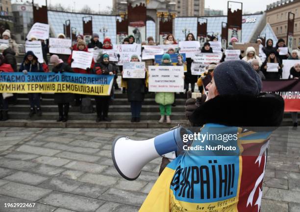 Participants are holding placards during a protest by military relatives who are demanding the demobilization of soldiers after 18 months of service...