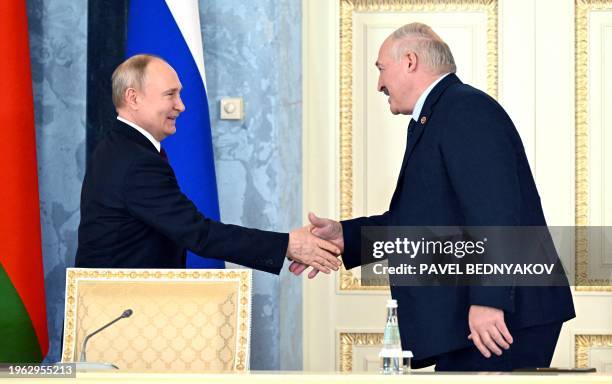 In this pool photograph distributed by Russian state agency Sputnik, Russia's President Vladimir Putin and Belarus' President Alexander Lukashenko...