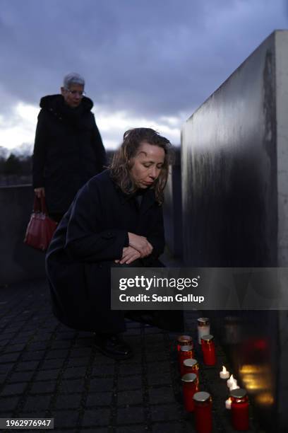 Local people light candles among stelae at the Memorial to the Murdered Jews of Europe, also called the Holocaust Memorial, on the eve of...