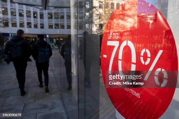 Red 70% January sale sign for major high street clothing retail shops on 18th January 2024 in London, United Kingdom. Its time for the Winter sales,...