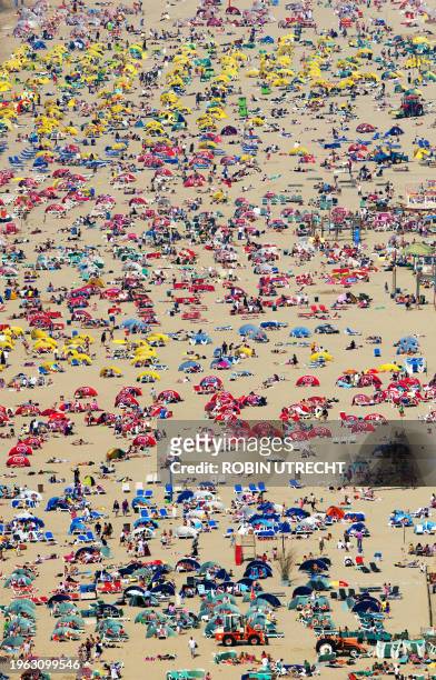 Sunbathers enjoy the beautiful weather in this aerial shot of the beach of Zandvoorton on April 24, 2011. AFP PHOTO/ANP/ROBIN UTRECHT netherlands out...