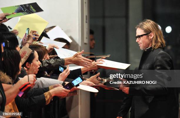 Actor Brad Pitt is welcomed by Japanese fans upon his arrival at the Japan premiere of his latest film "Moneyball' in Tokyo on November 9, 2011. The...